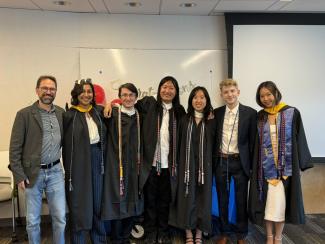 A group of graduates posing with Undergraduate Chair Florian Schwarz.
